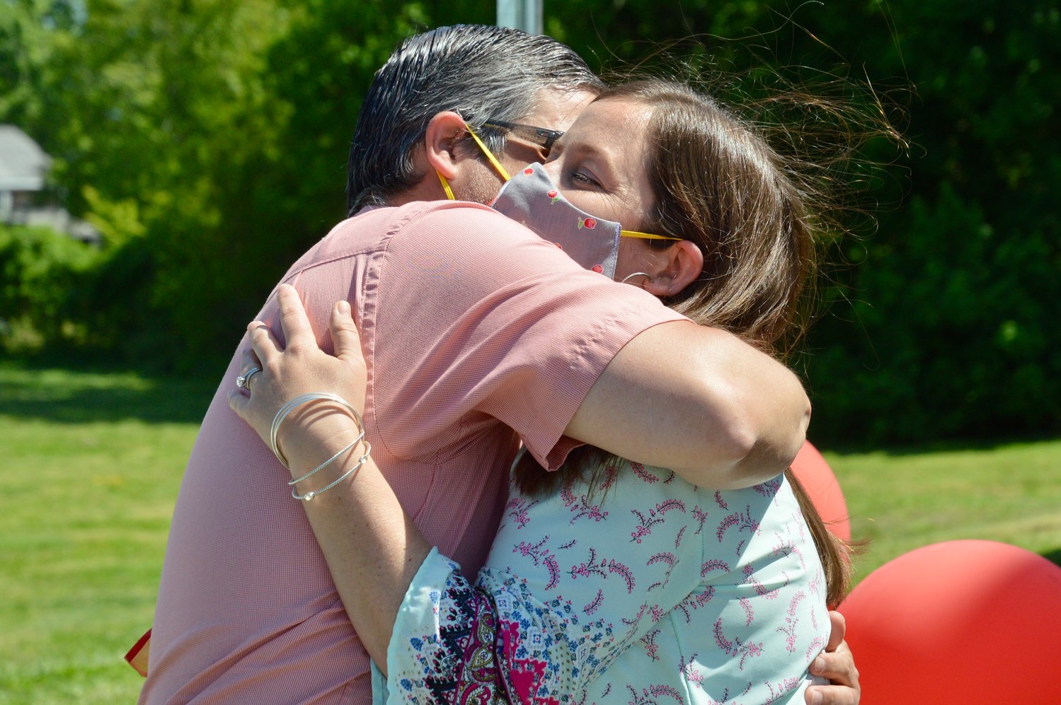 Ashley Adamson receives a hug from her husband, John.