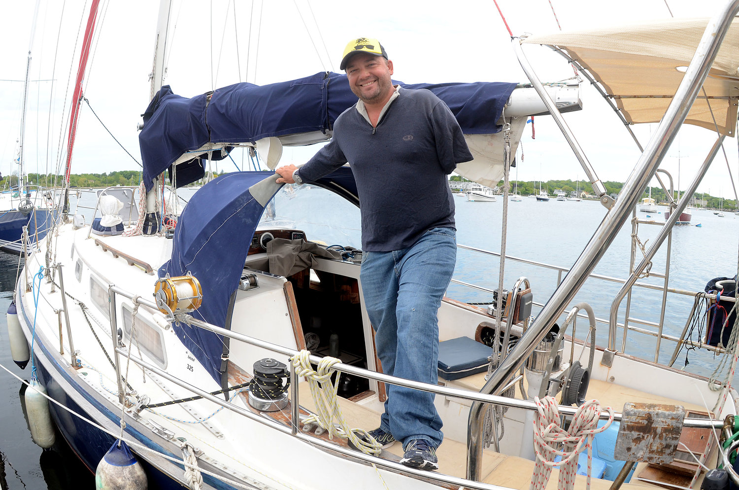 Dustin Reynolds stands aboard Tiama, a Bristol 35 originally launched from Bristol Marine 37 years ago and now docked there for a short time. After losing two limbs when a drunk driver hit him head-on, he decided to sail around the world alone — after he first learned how to sail.