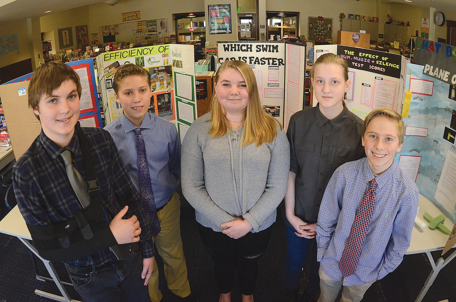 (From left to right) Indiana Pacheco, Archie Rebeiro, Morgan Pattison, Olivia Watters and Ty Polasek, eighth graders at Wilbur McMahon School in Little Compton, show off the projects that qualified them for the Junior Division of the Rhode Island Science and Engineering Fair that was ultimately canceled in March.