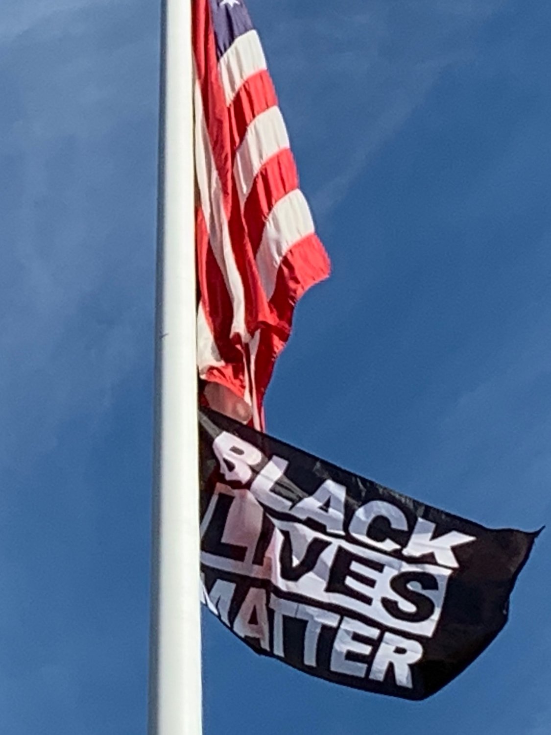 The Black Lives Matter flag flies on the pole outside Barrington Town Hall.