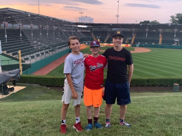 Gabe, Lucas and Sam Tanous (from left to right) pose for a photo outside one of the fields at the Little League World Series in Williamsport, Pa.