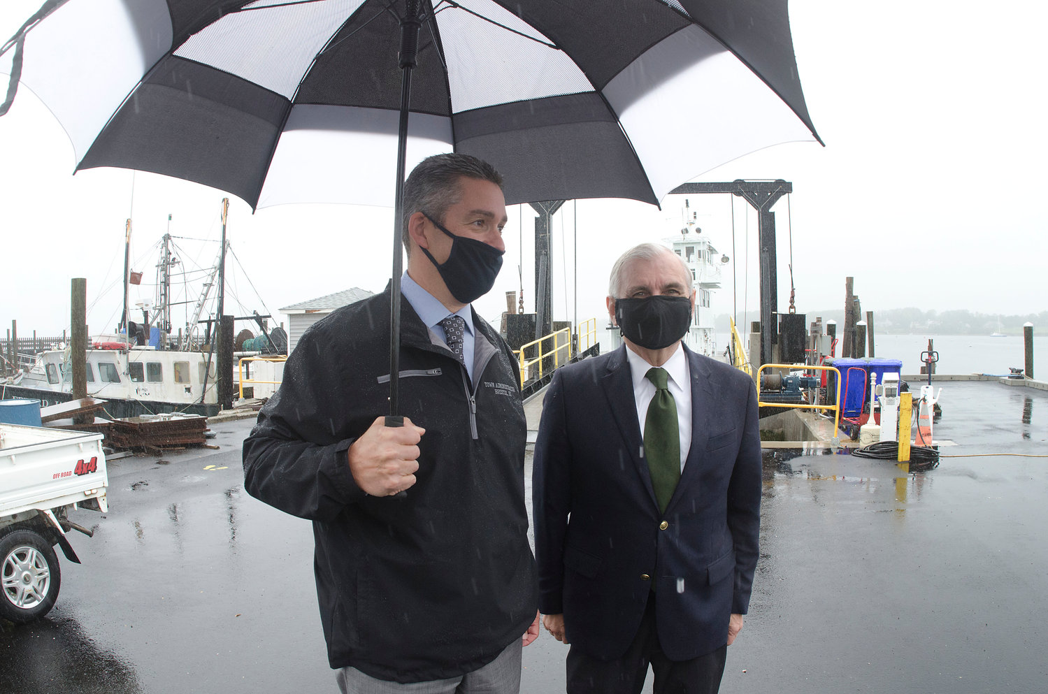 Town Administrator Steve Contente (left) gives a quick tour of the Church Street and Prudence Island Ferry docks to Sen.Jack Reed on a drizzly Tuesday morning.