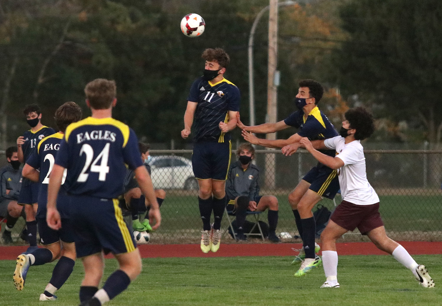 Dan Enos rises up for a header, while teammate Ned Shapiro (right) moves in. Barrington and Tiverton played to a 0-0 tie in a non-league game last week.