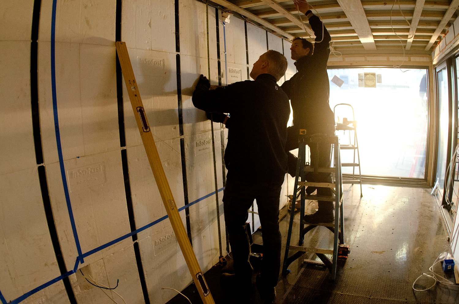 Barrington's Anders Hansen (left) and Andrew Naperotic work inside one of the new ADDASPACE living/working units. The company is focused on making the design, construction, permitting and installation phases of the work easier for the customer.