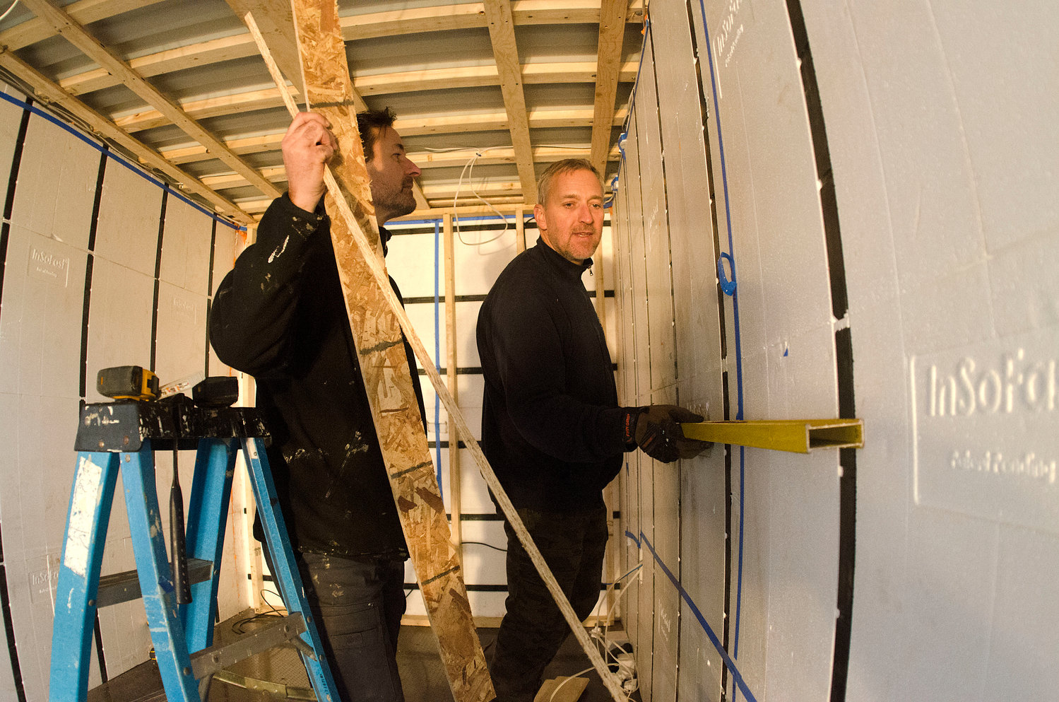 Barrington's Andrew Naperotic (left) and Anders Hansen work inside one of the new ADDASPACE living/working units. The company is focused on making the design, construction, permitting and installation phases of the work easier for the customer.
