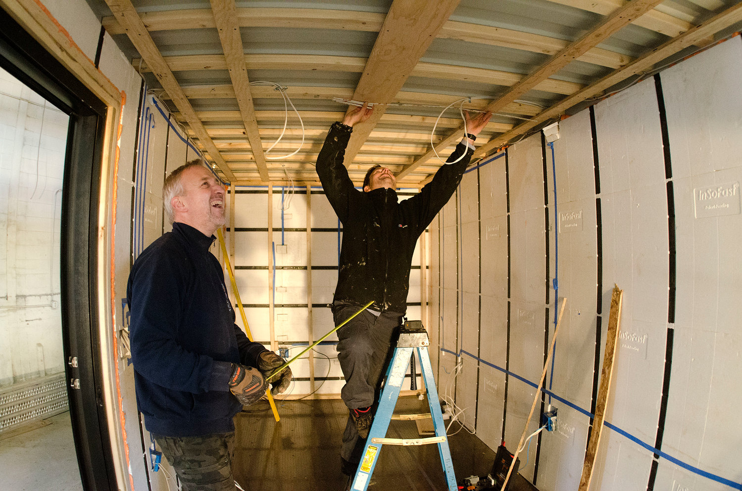 Barrington's Anders Hansen (left) and Andrew Naperotic work inside one of the new ADDASPACE living/working units. The company is focused on making the design, construction, permitting and installation phases of the work easier for the customer.