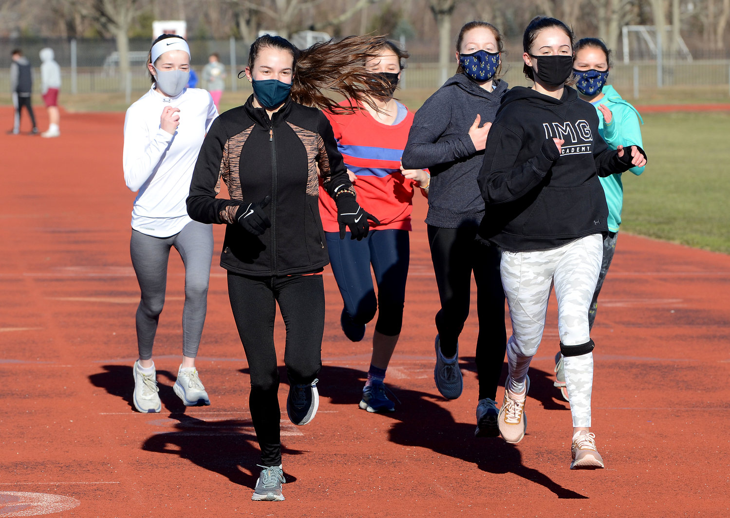 Members of the Barrington High School girls indoor track team run through a practice session on the outdoor track on Monday morning, Jan. 18. Pictured are (from left to right) Kyle Keough, Lindsay Turgeon, Jane Bryant, Virginia Sanderson, Maeve Murphy and Tosca Barako taking a warm-up lap before the start of the work-out.