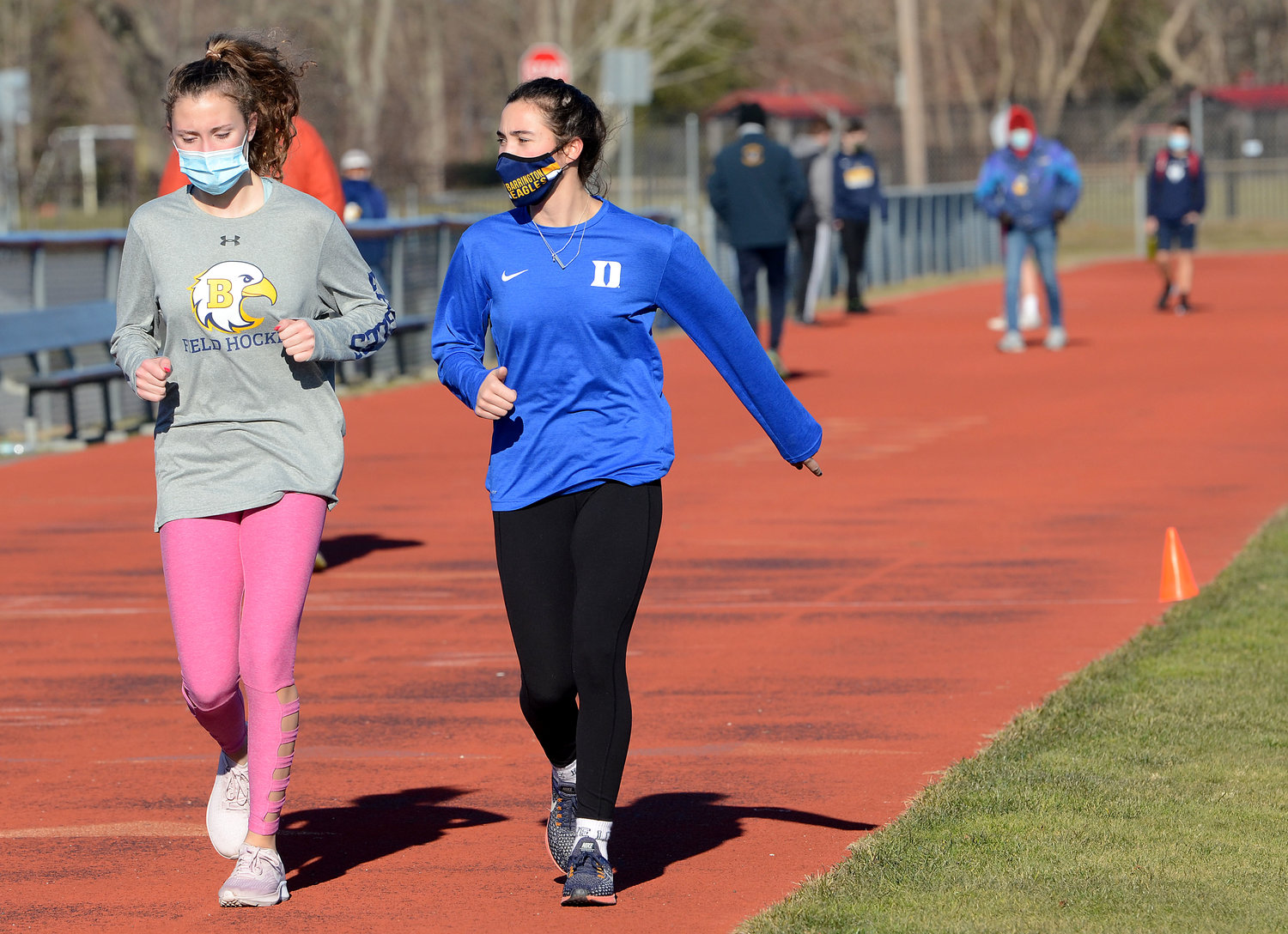 Violet Gagliano (left) and her sister Tess take a cool down lap after sprints.