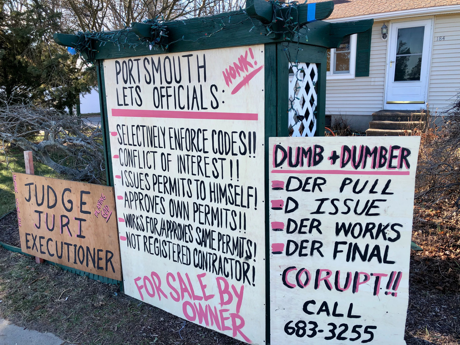 Examples of signs that were erected in front of a Bristol Ferry home by local resident Michael DiPaola, and which were the target of a notice of violation from the Town of Portsmouth. The ACLU has now filed a lawsuit against the town, challenging the zoning ordinance.