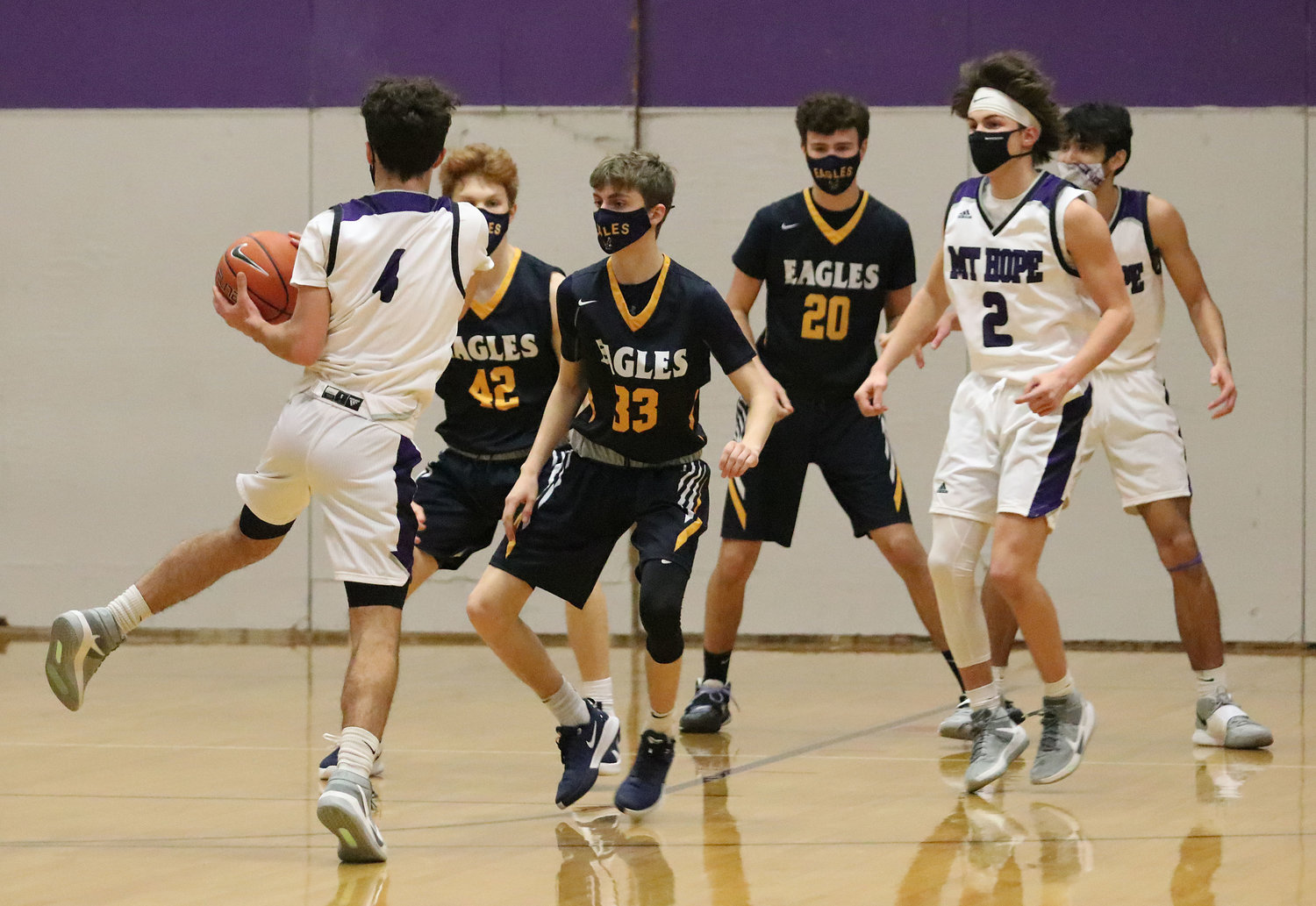Barrington defenders Brigham Dunphy (left), Sean Bonneau, and Nick Scandura get into their defense as Mt. Hope's Parker Camelo brings up the ball during a non-league game in Bristol on Monday night. Barrington won 77-40.