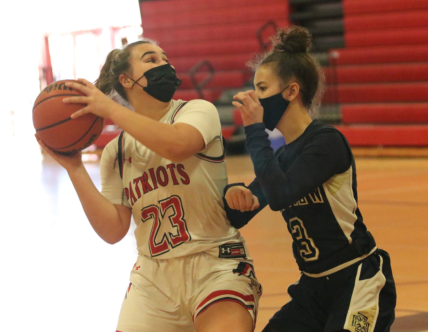 Patriots guard Emily Maiato is pressured by a Bay View defender while looking for an open shot.