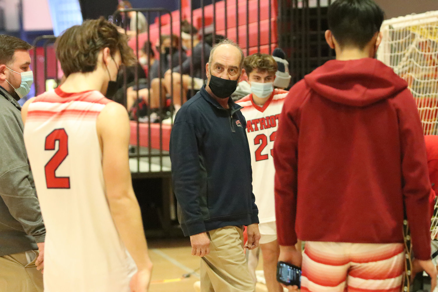 Joe Occhi, head coach of the Patriots boys’ varsity basketball team, meets with his players following their win Saturday in the PHS field house. “It’s a little bit fitting, I think, that we were the ones that closed this building in March and the ones to open it again now,” he said.