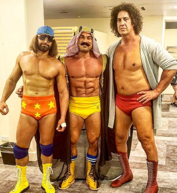 Barrington native Brett Azar (center) plays the role of The Iron Sheik in the new NBC sitcom, Young Rock. Here he is pictured with actors playing the roles of Macho Man Randy Savage (left) and Andre the Giant.