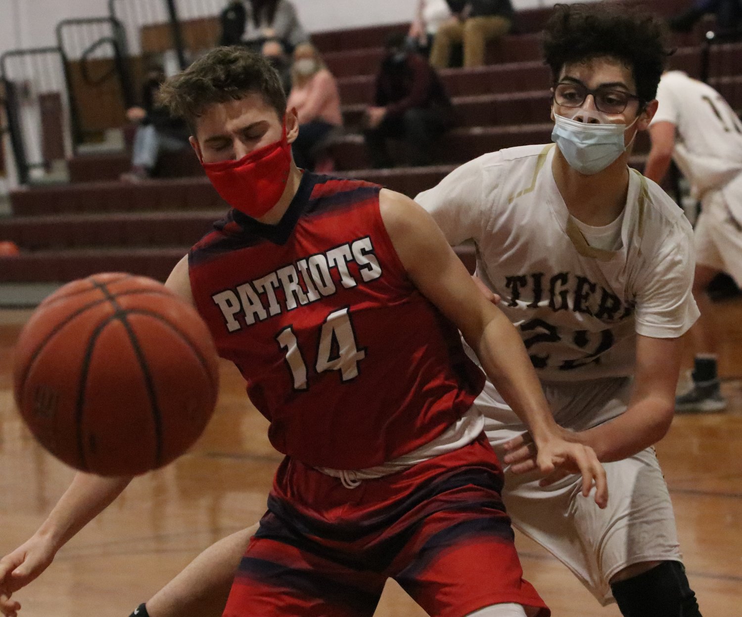 Sophomore forward Nate Sama punches the ball out of a Patriots' hands. 