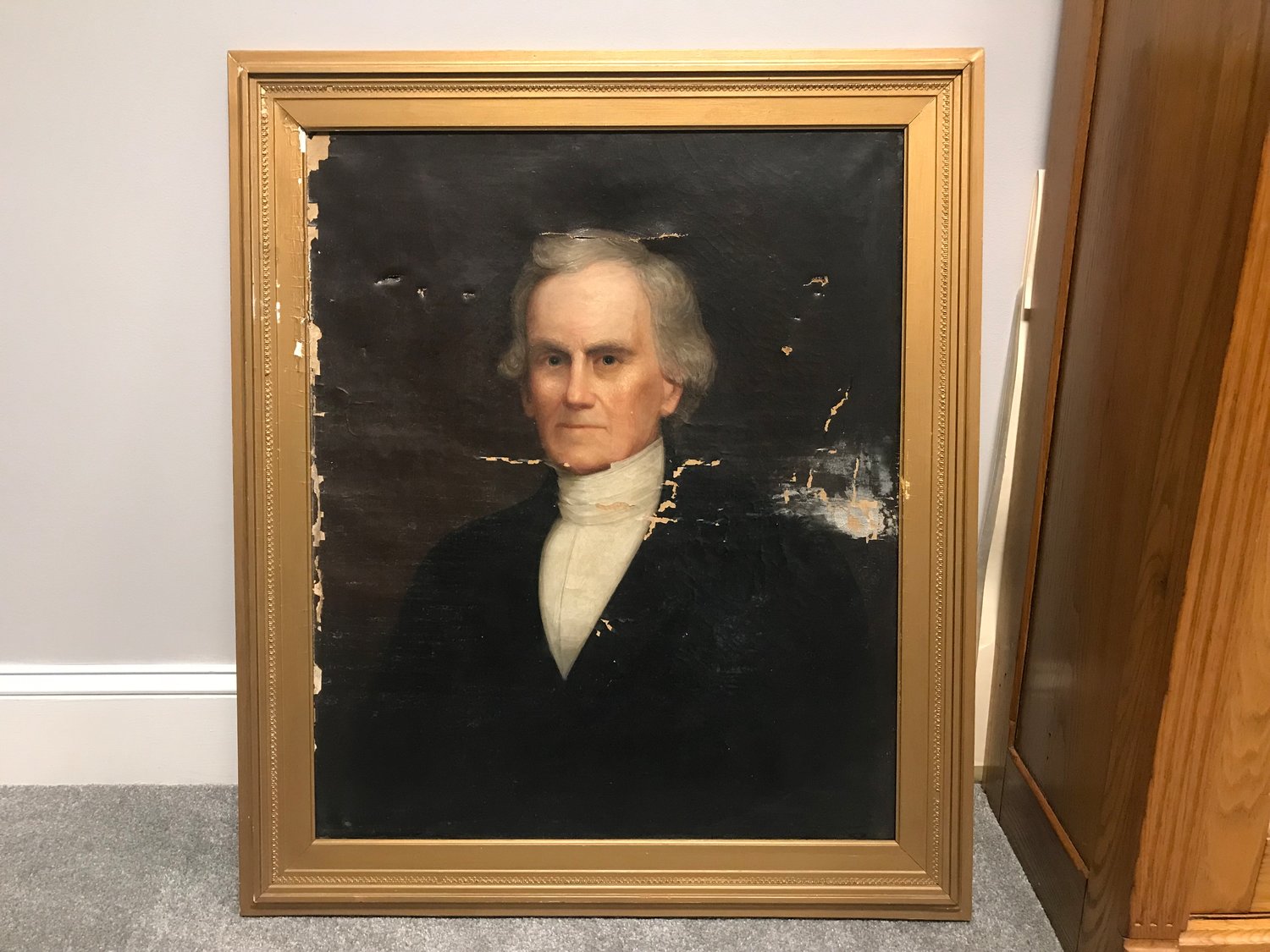 This painting of the first superintendent of Bristol schools was damaged while sitting in a basement for many years. It may take about $5,500 to restore it.