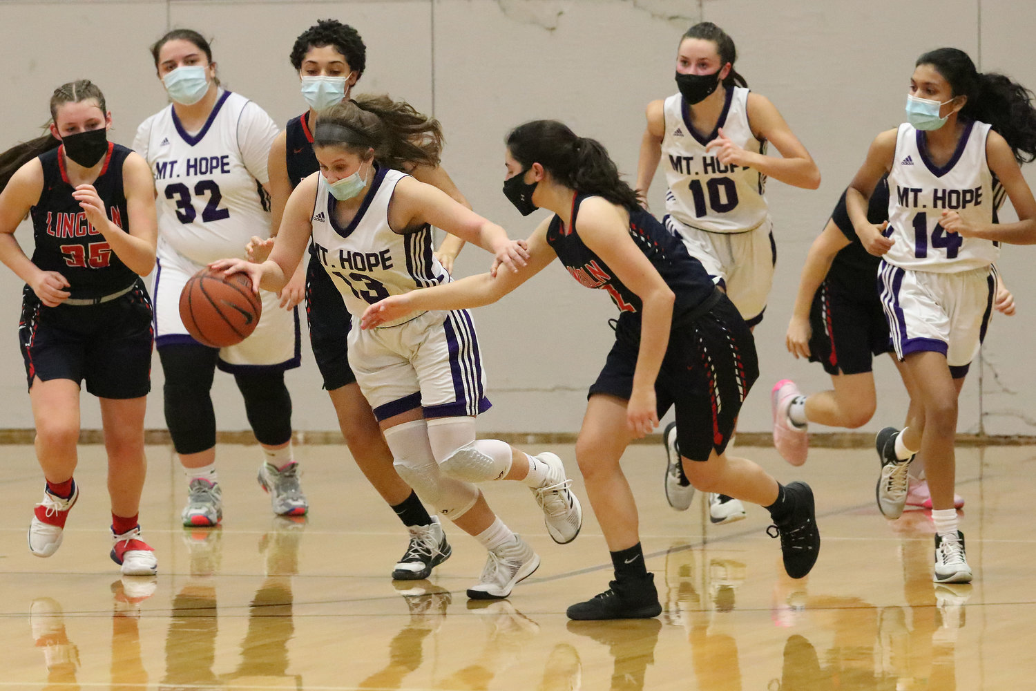 Sophomore point guard Abby Razzino fights her way up court after pulling down a rebound with teammates Lauren Pais (left), Reyn Ferris and Aditi Mehta.