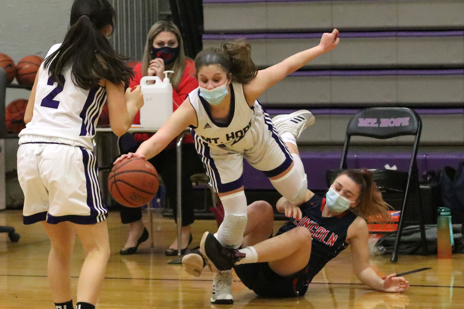 Sophomore point guard Abby Razzino steps over a Lincoln player after stealing the ball along the sidelines in the second quarter.
