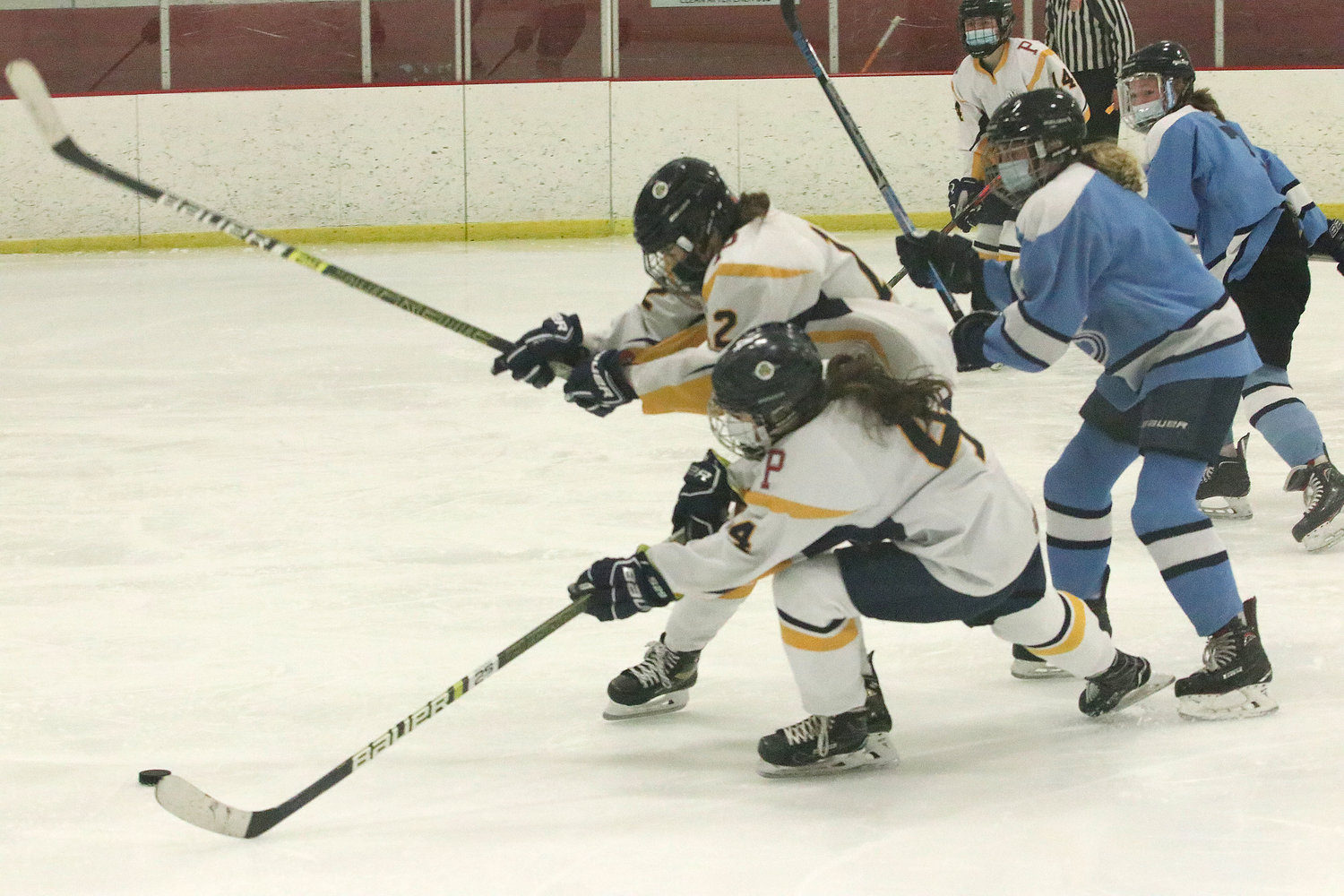Kat Barker (left) and Marissa Levreault vie for the puck in front of the Narragansett goal in the third period of Game 2.