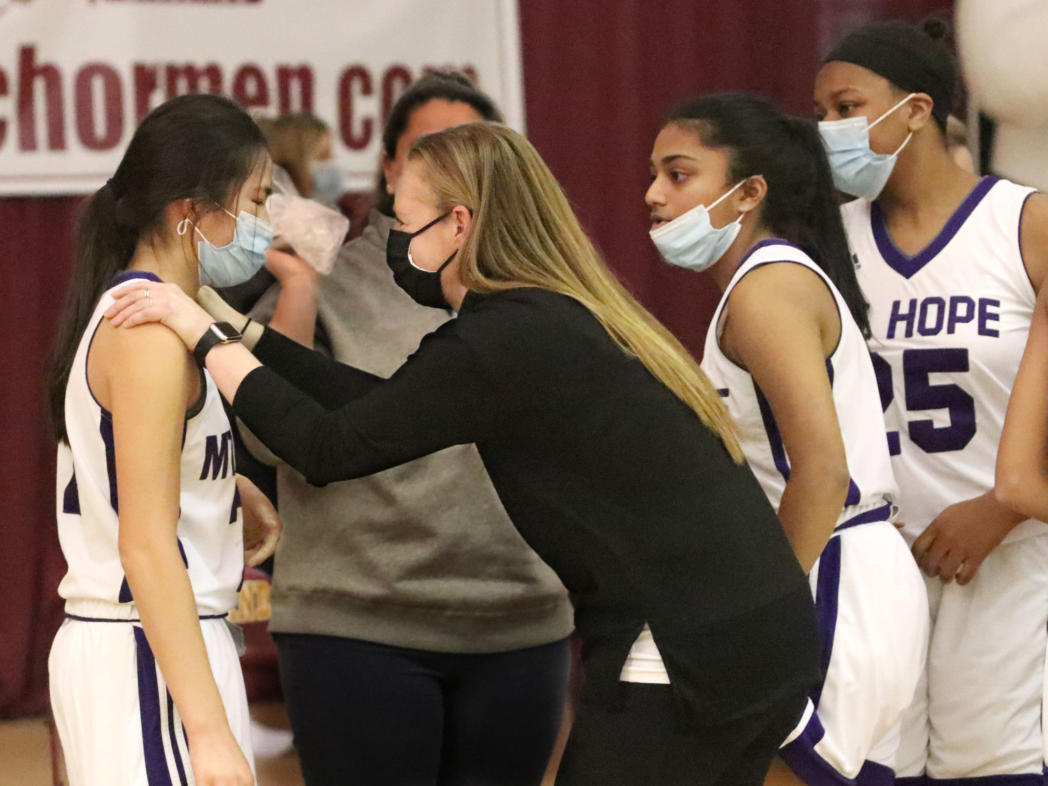 Coach Caitlin Booth settles Elsa White down after the game. With Aditi Metha and Amani Jackson (right).