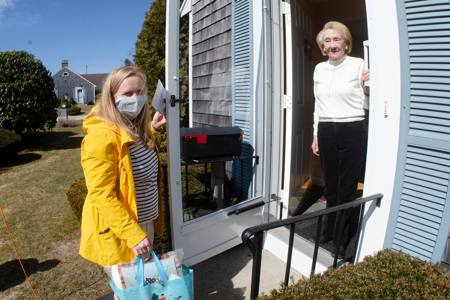 Gloria Newman (right) greets R.I. Meals on Wheels Executive Director Meghan Grady at her door last week.