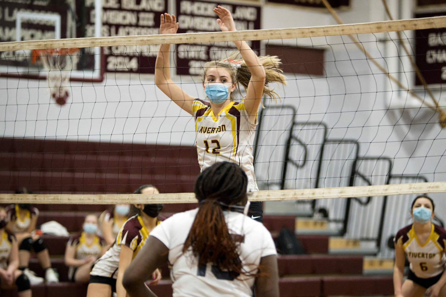 Molly Richardson blocks the net during Tuesday night's game against
Paul Cuffee School.