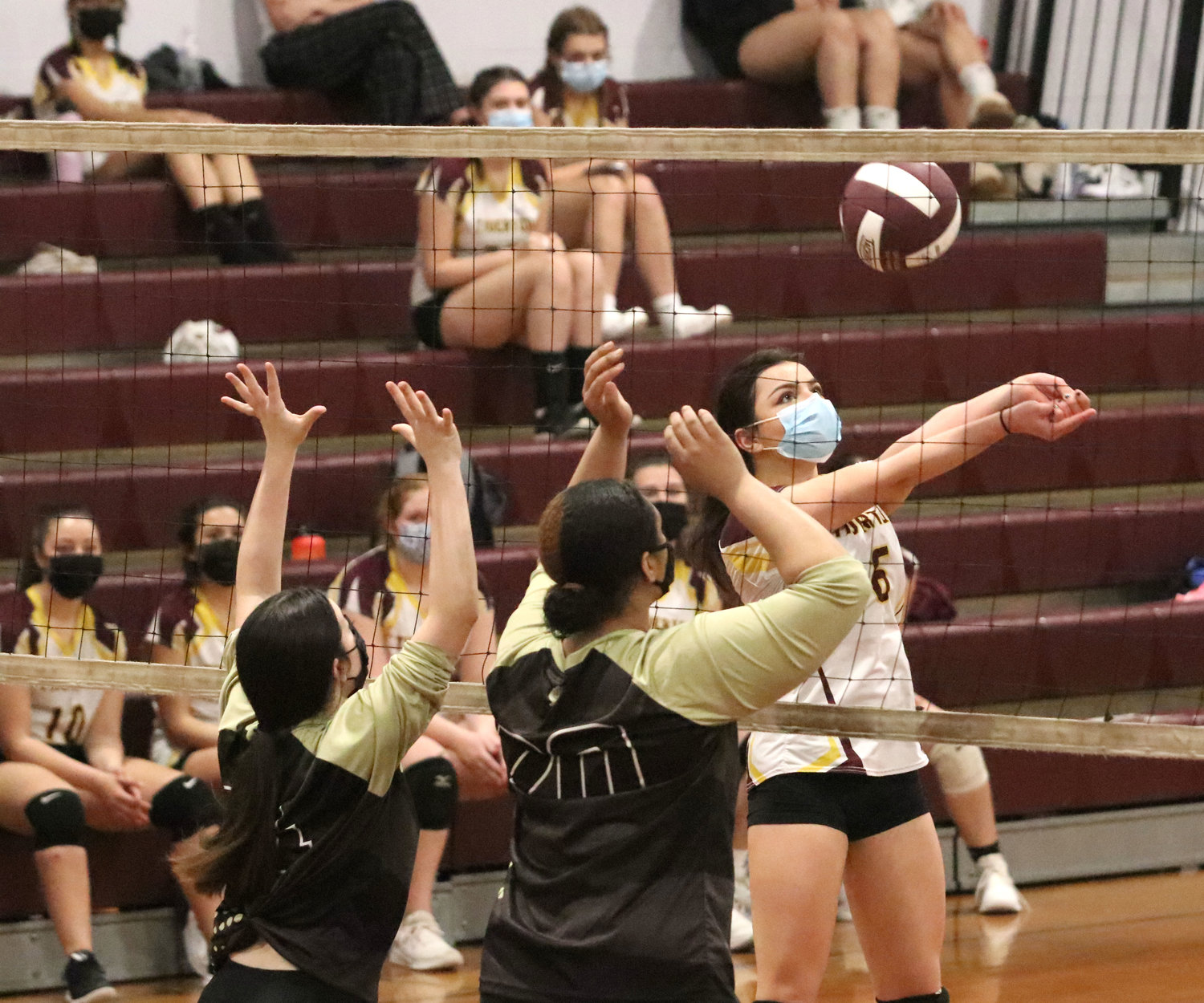 Gabby Piscani volleys the ball over the net.