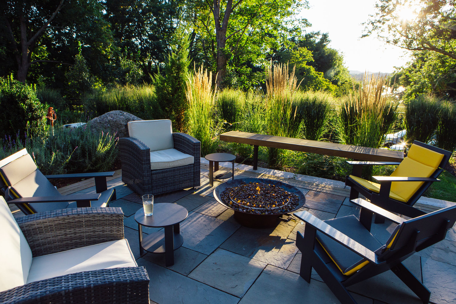 The fire pit area adjoining the pool enjoys its own private space, with natural grasses providing the relaxing atmosphere one would expect in this setting.