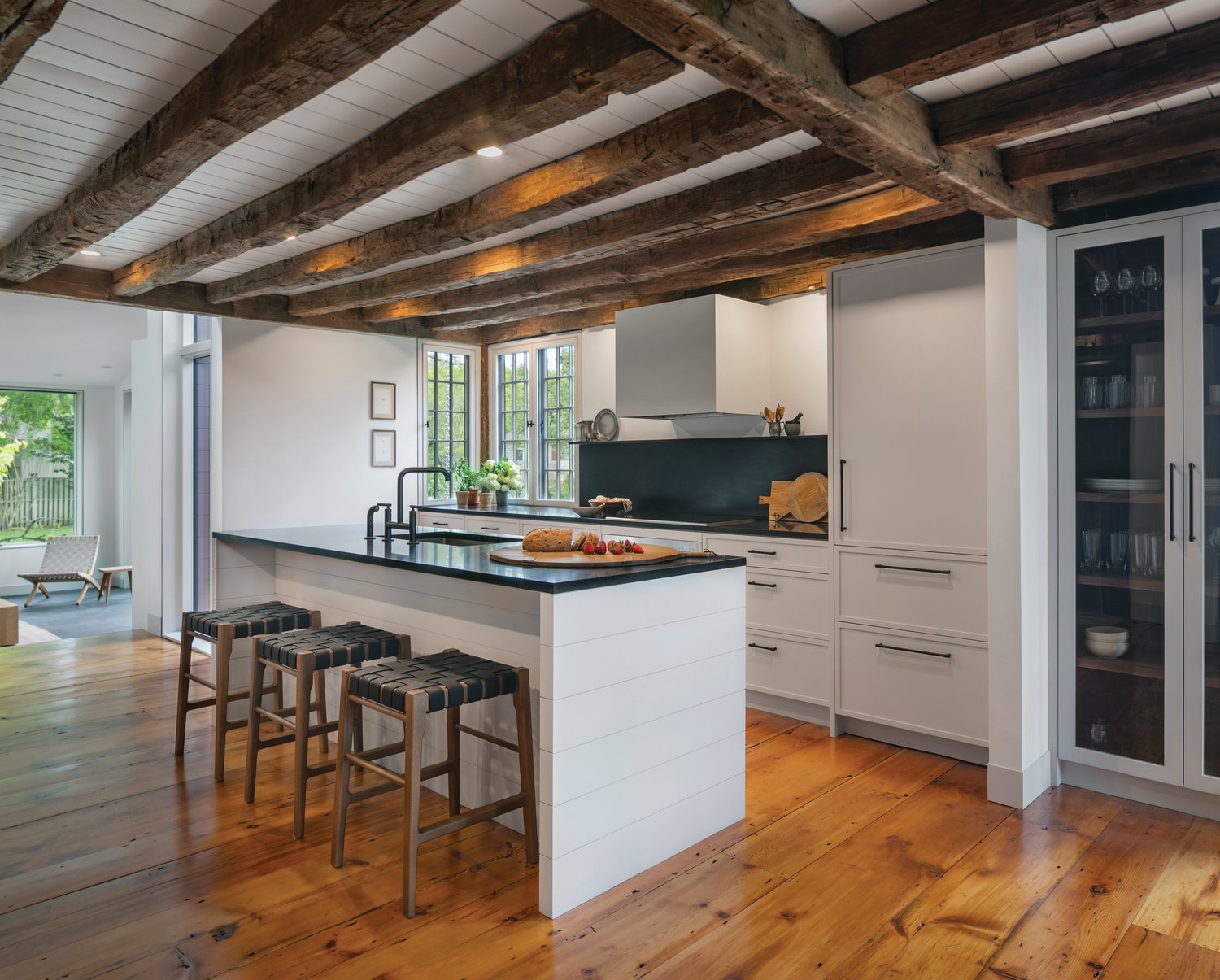 The kitchen is the perfect representation of the old-meets-new concept, with original beams and wide, plank floor boards framing a luxurious but simple, modern kitchen.