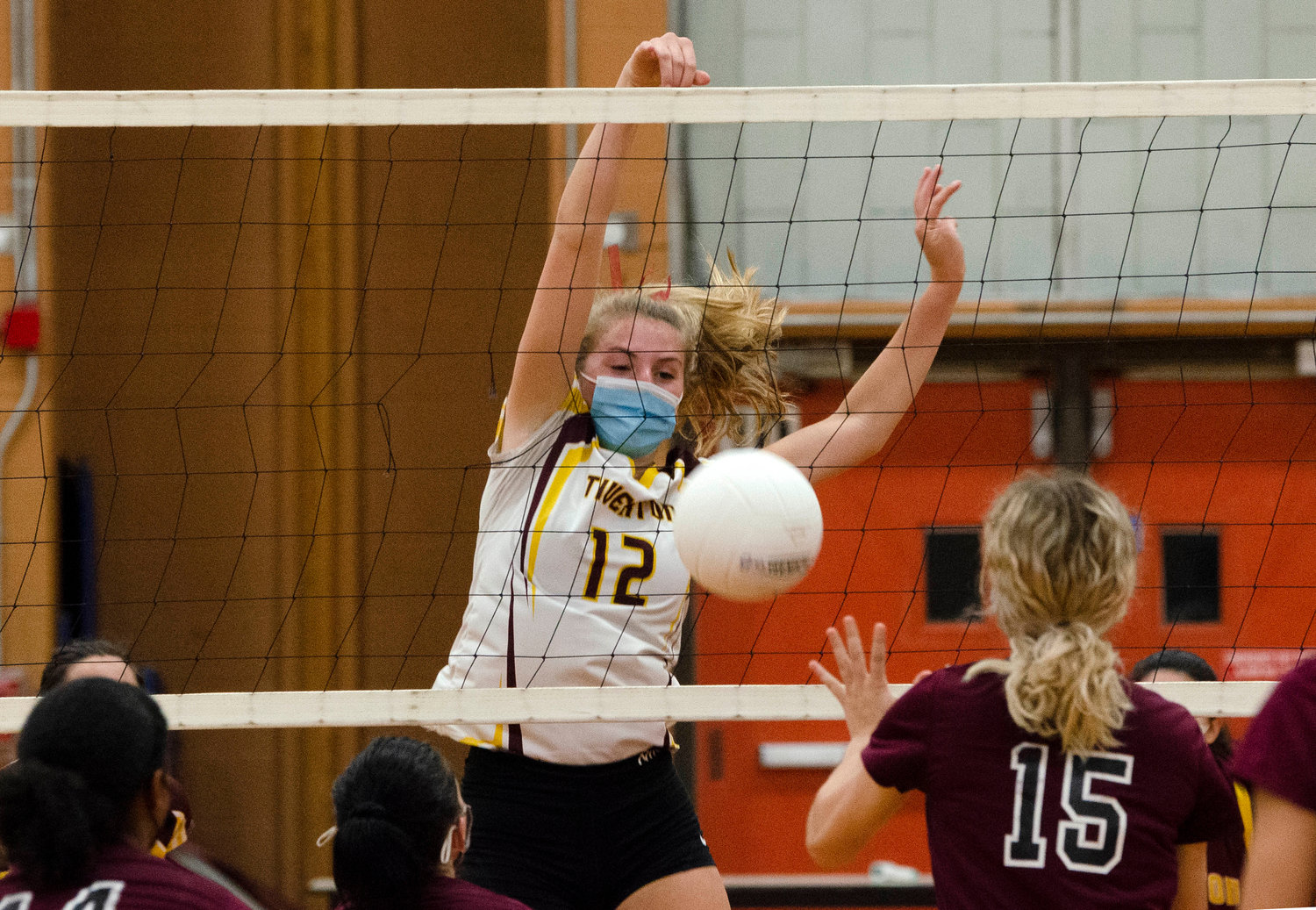 Tigers junior inside/outside hitter, Molly Richardson volleys and taps the ball over the net for a kill during the team's semifinals match against Woonsocket. 
