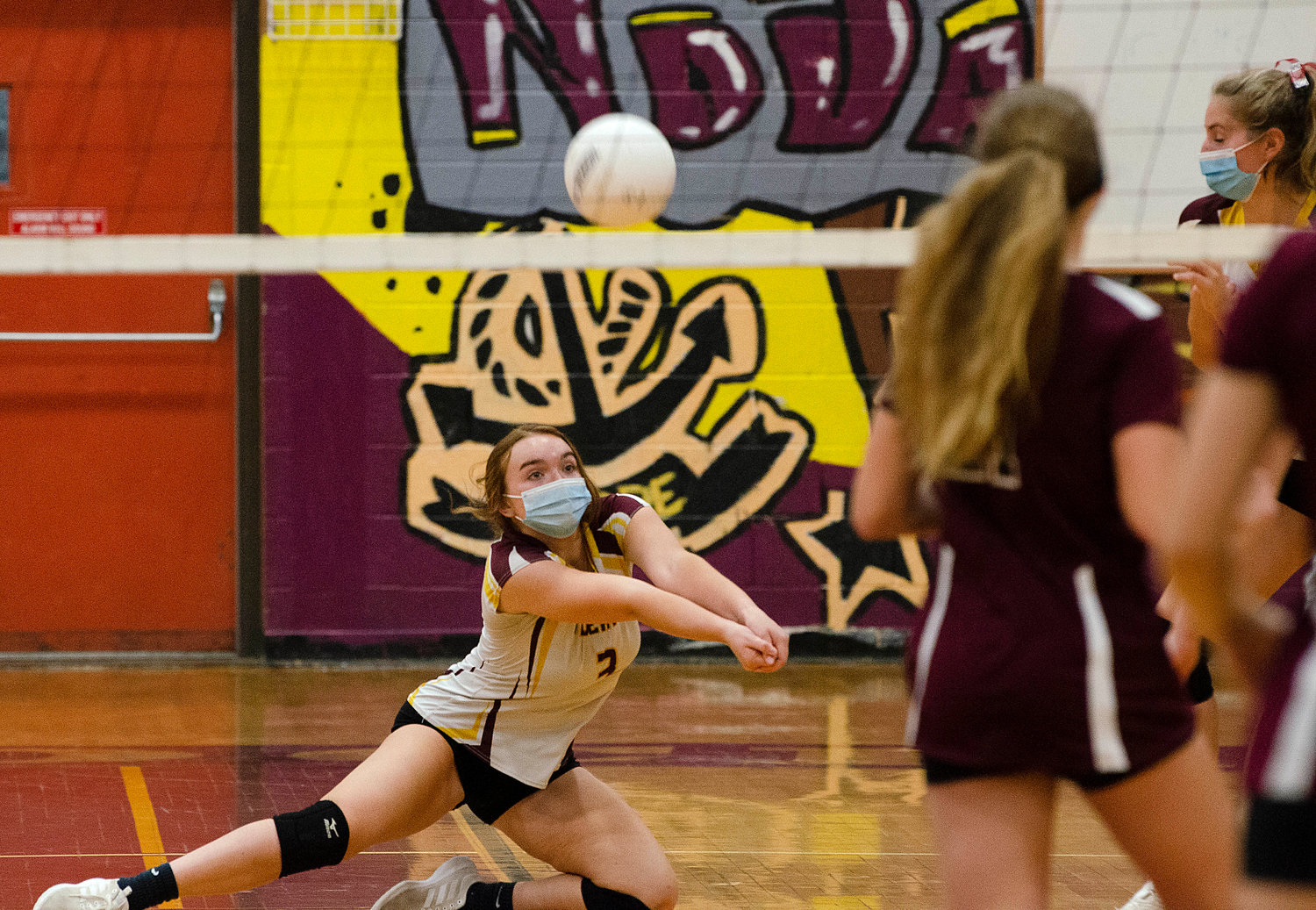 Junior outside hitter Emily Oaks digs the ball out from in front of the net.