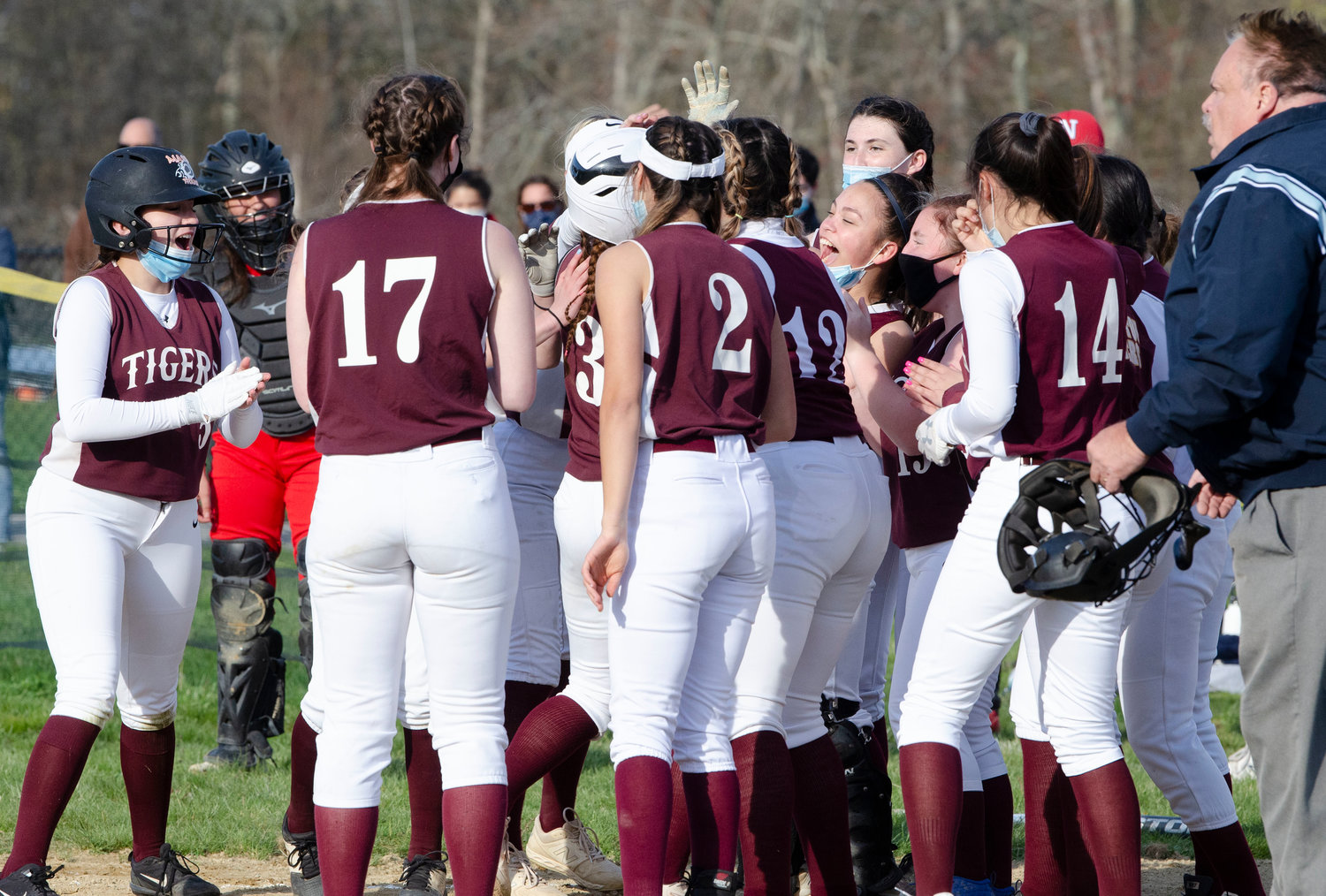 Tiverton teammates cheer on Emily Oaks as she steps on home after hitting a home run to left-centerfield in the second inning to give the Tigers a 1-0 lead. 