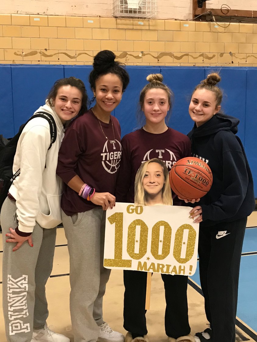 Mariah Ramos (second from right) celebrates another milestone  with teammates— her 1,000th point as a THS basketball player.