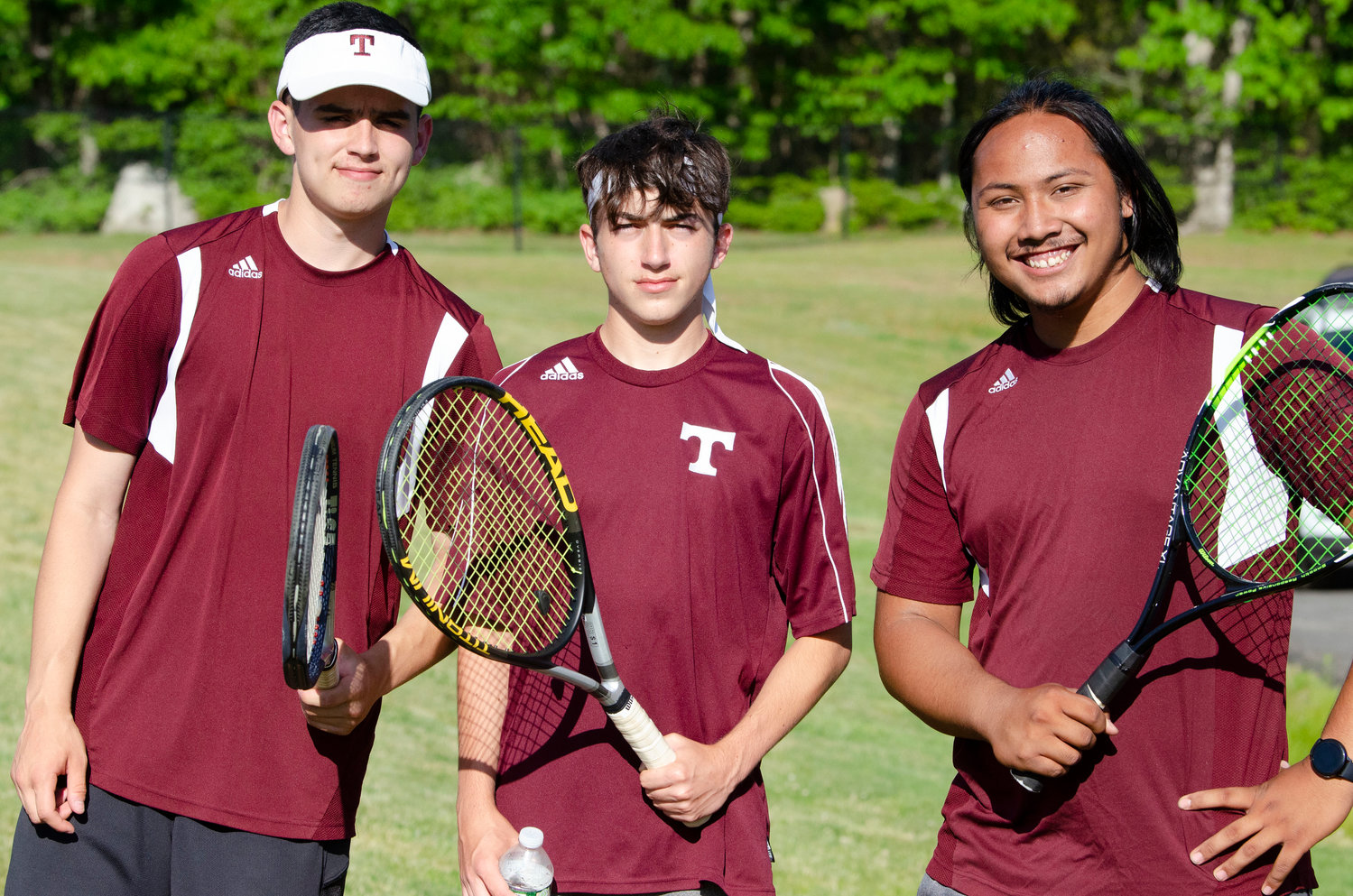 Second doubles team, Tim borden (left) and Jarred Rogers pose with teammate Fred Bebe.