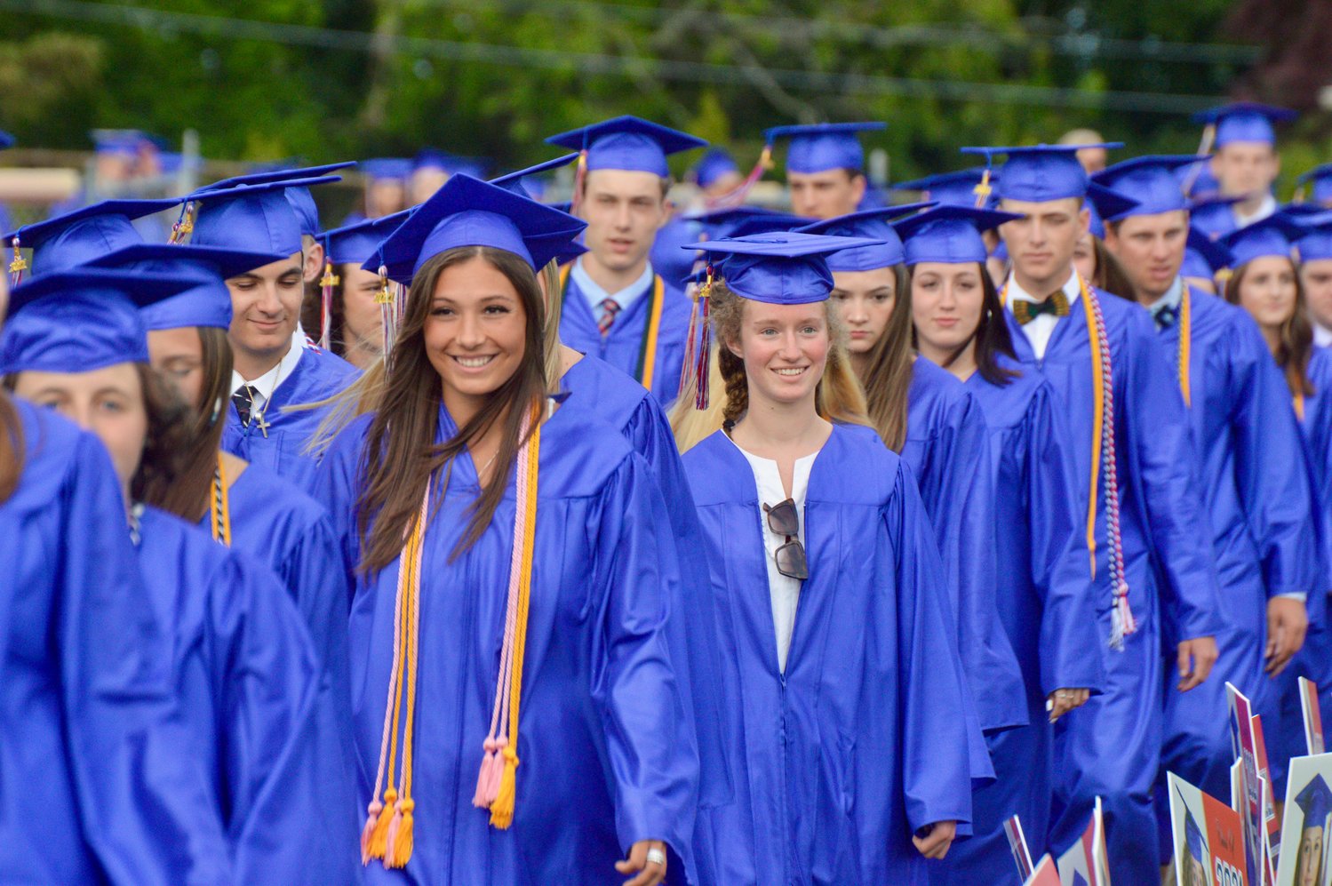 Members of the Class of 2021 march from the school to the baseball field, where graduation was held.