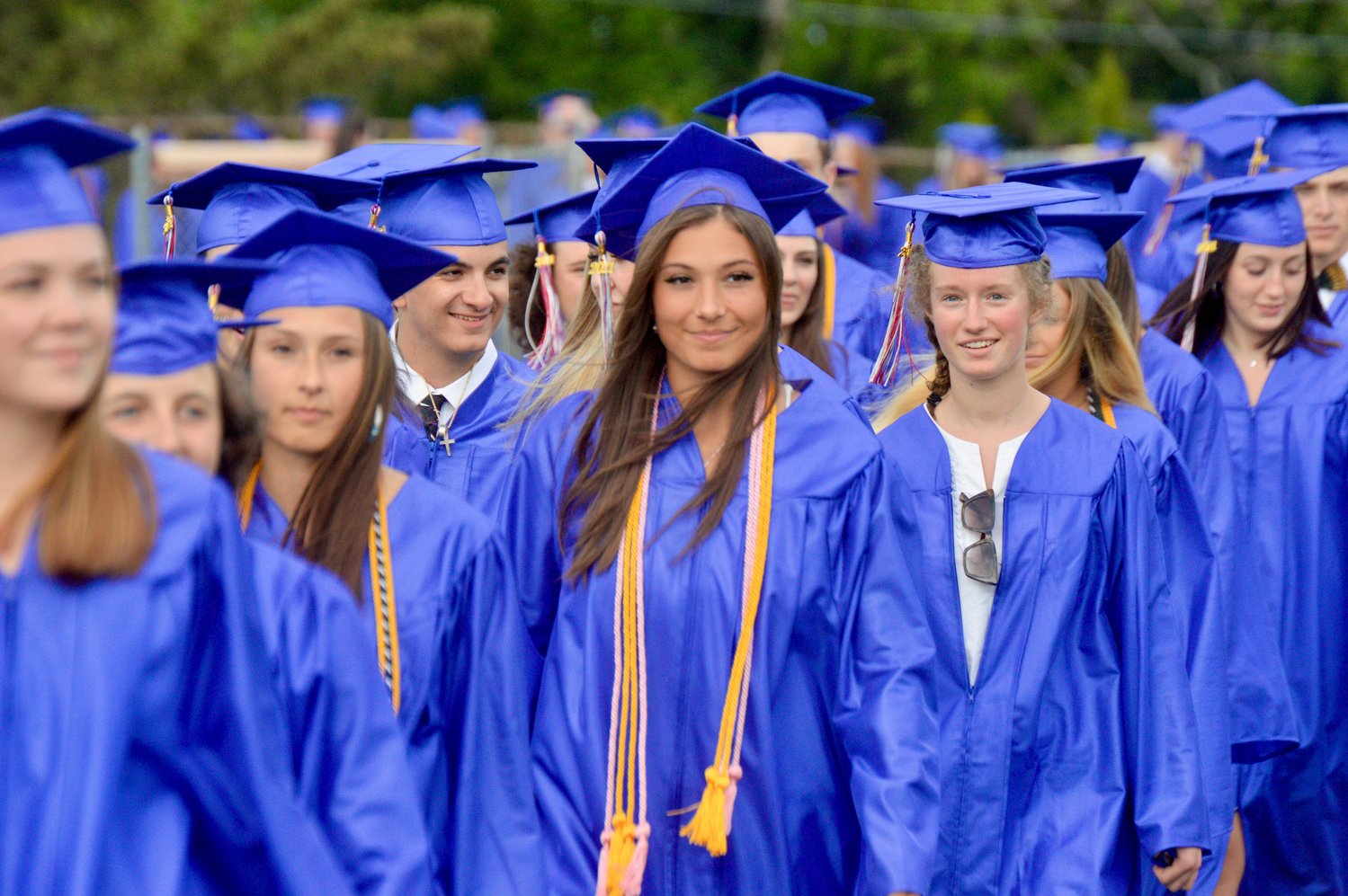 Members of the Class of 2021 march from the school to the baseball field, where graduation was held.