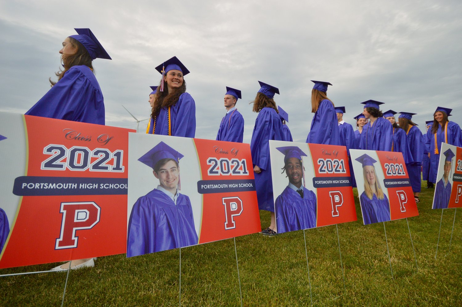 Graduating seniors marched to the baseball field between individual signs that were made up for each student to take home.