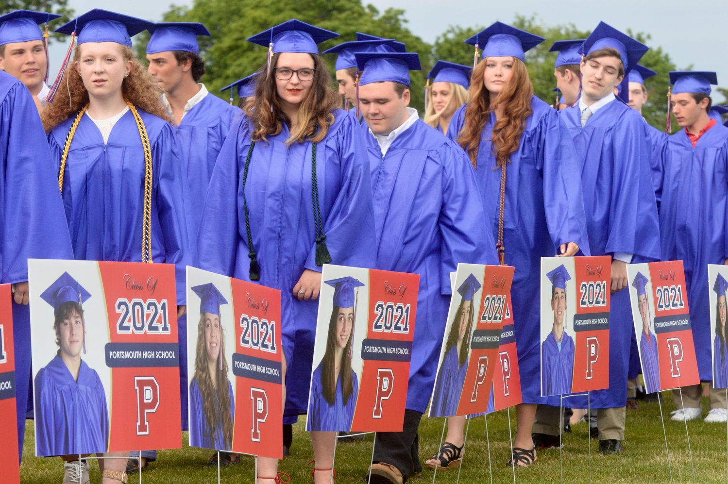 Graduating seniors marched to the baseball field between individual signs that were made up for each student to take home.
