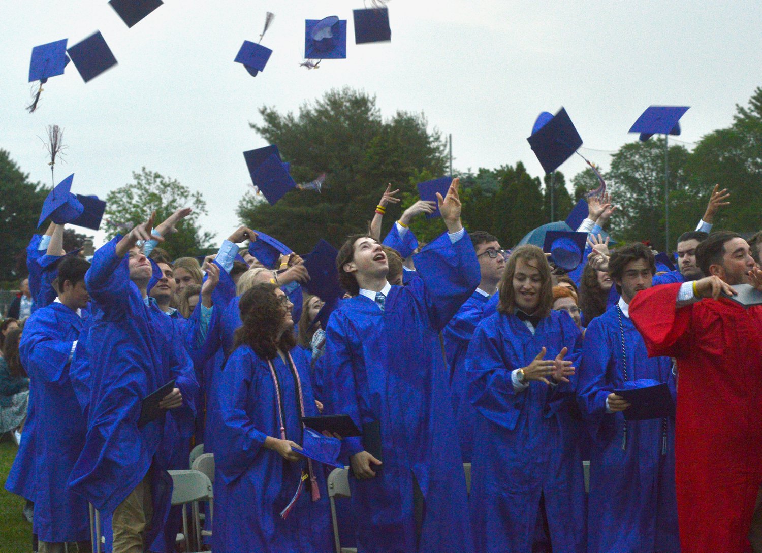 Graduating seniors toss their caps into the air at the end of the ceremony.