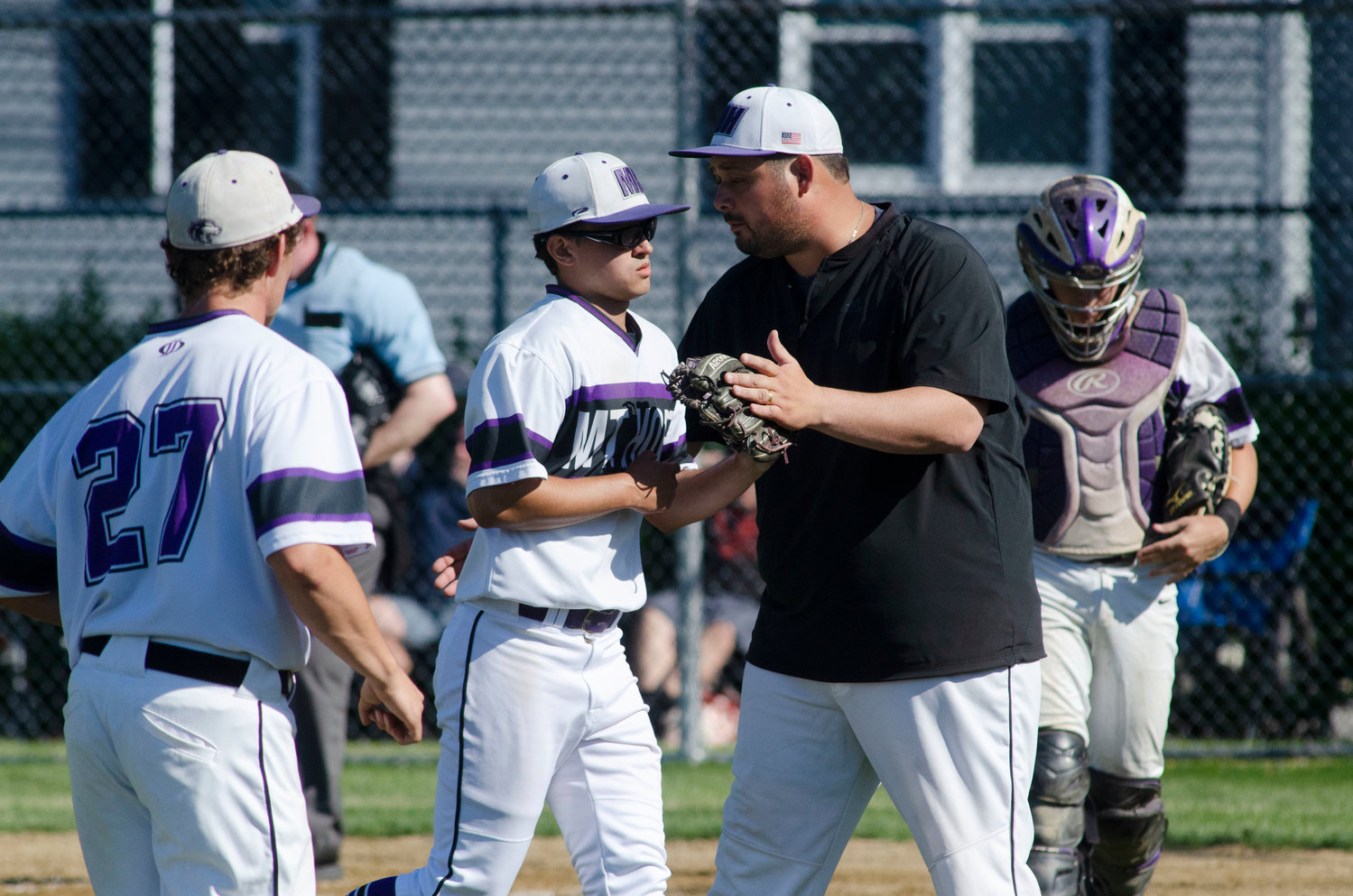 Huskies head coach celebrates with pitcher Ethan Leary after a strike out to end the third inning.