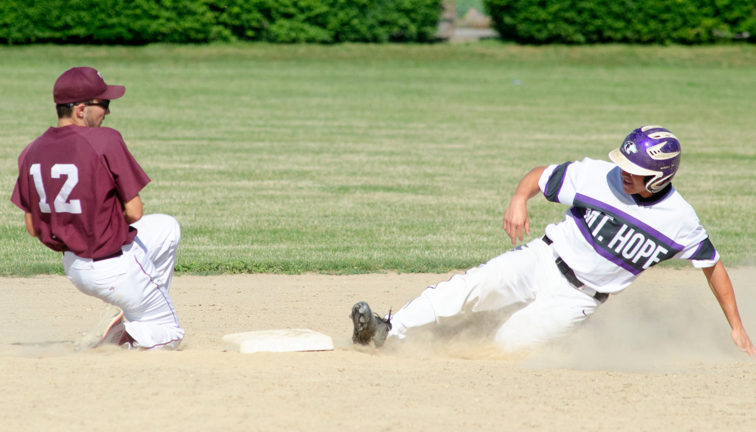 Shortstop Jameson Peckham corals the throw while Huskies Cam Connor steals second base.