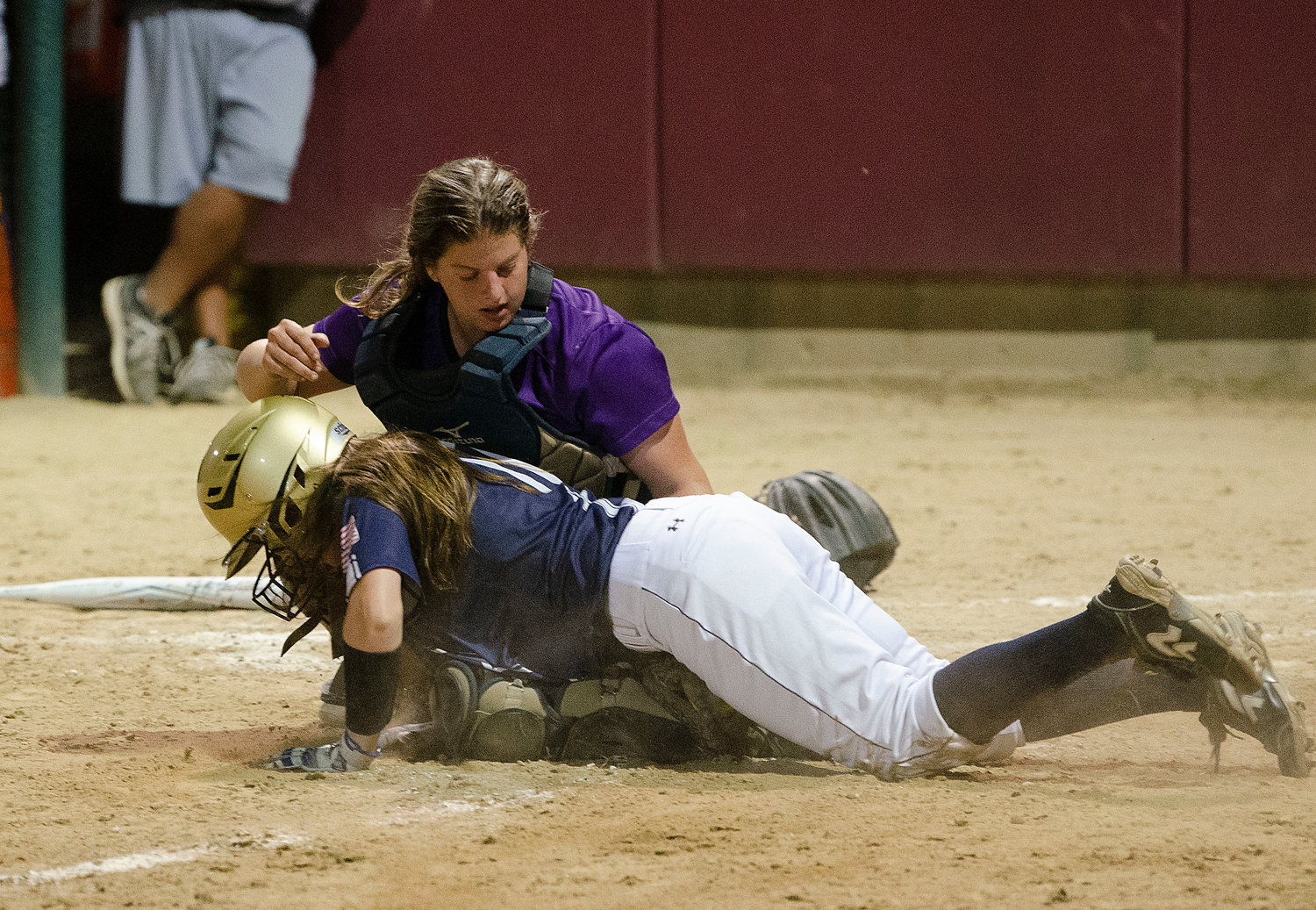 Catcher Grace Stephenson blocks the plate and tags out Kaitlyn Gould in the fifth inning. Left fielder Elsa White assisted on the play.