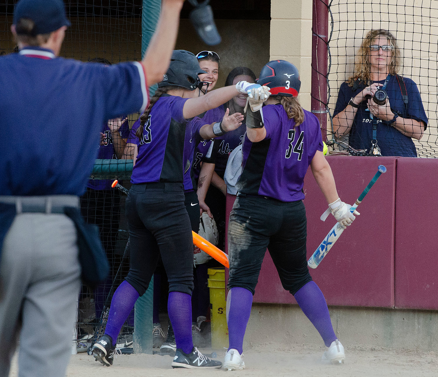 The Huskies celebrate with Stephenson after she crossed home plate to give Mt. Hope a, 2-0 , lead.