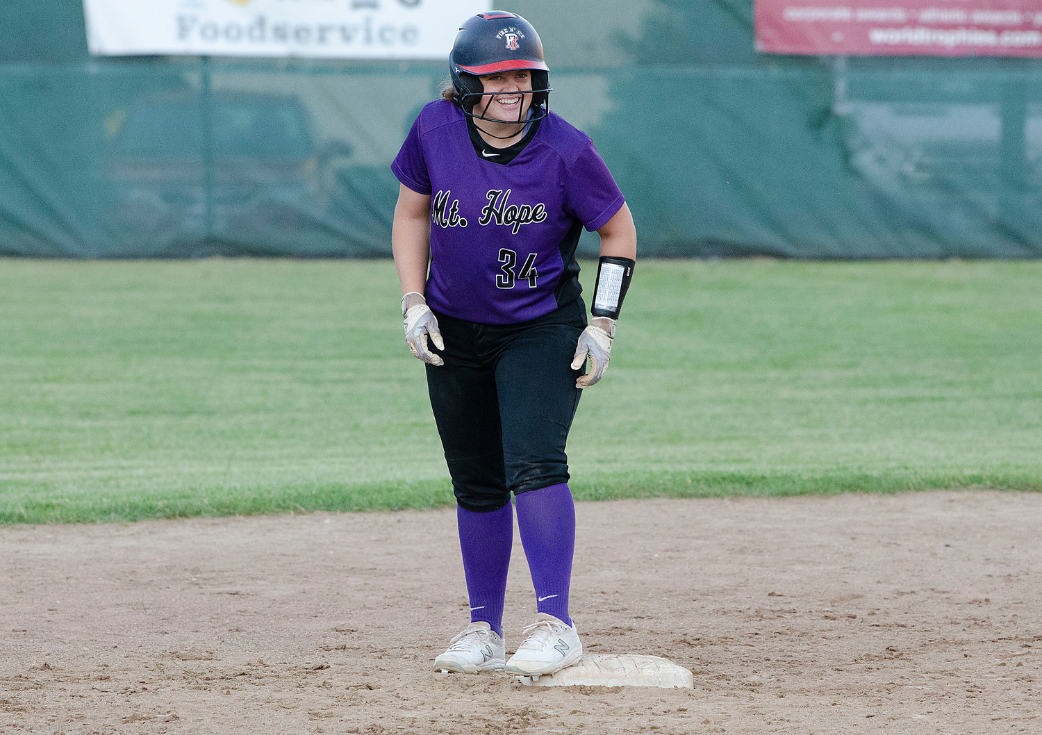 Grace Stephenson stands on second base and looks towards her screaming teammates in the dug out, after smacking a run scoring, double in the first inning.
