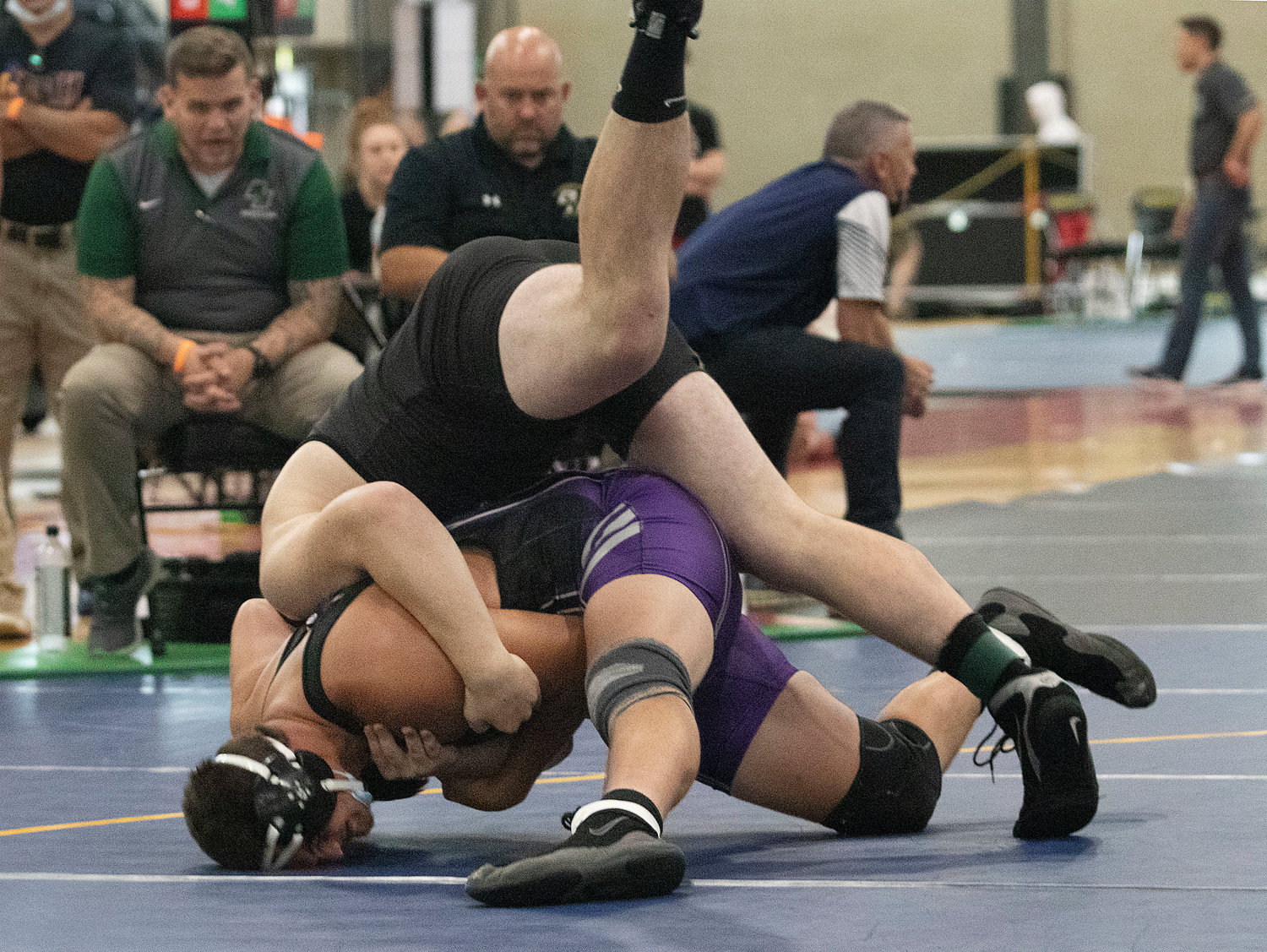 Atlley Jenness whips Hendricken's Adolfo Betancur over his hip during their semifinals match.
