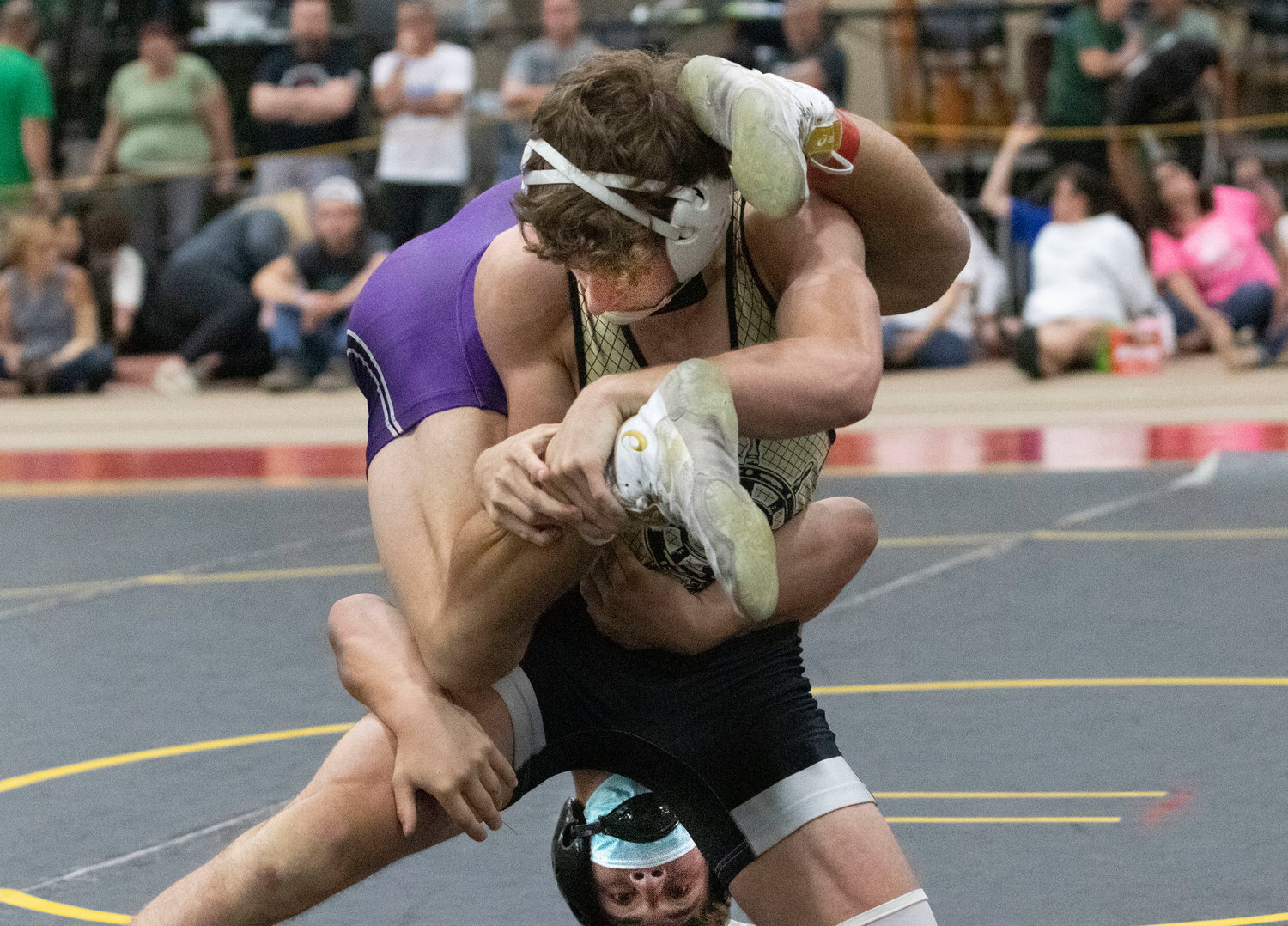 Brock Pacheco hangs on, after getting flipped over the shoulder of opponent, Aidan Zarella, during the finals.
