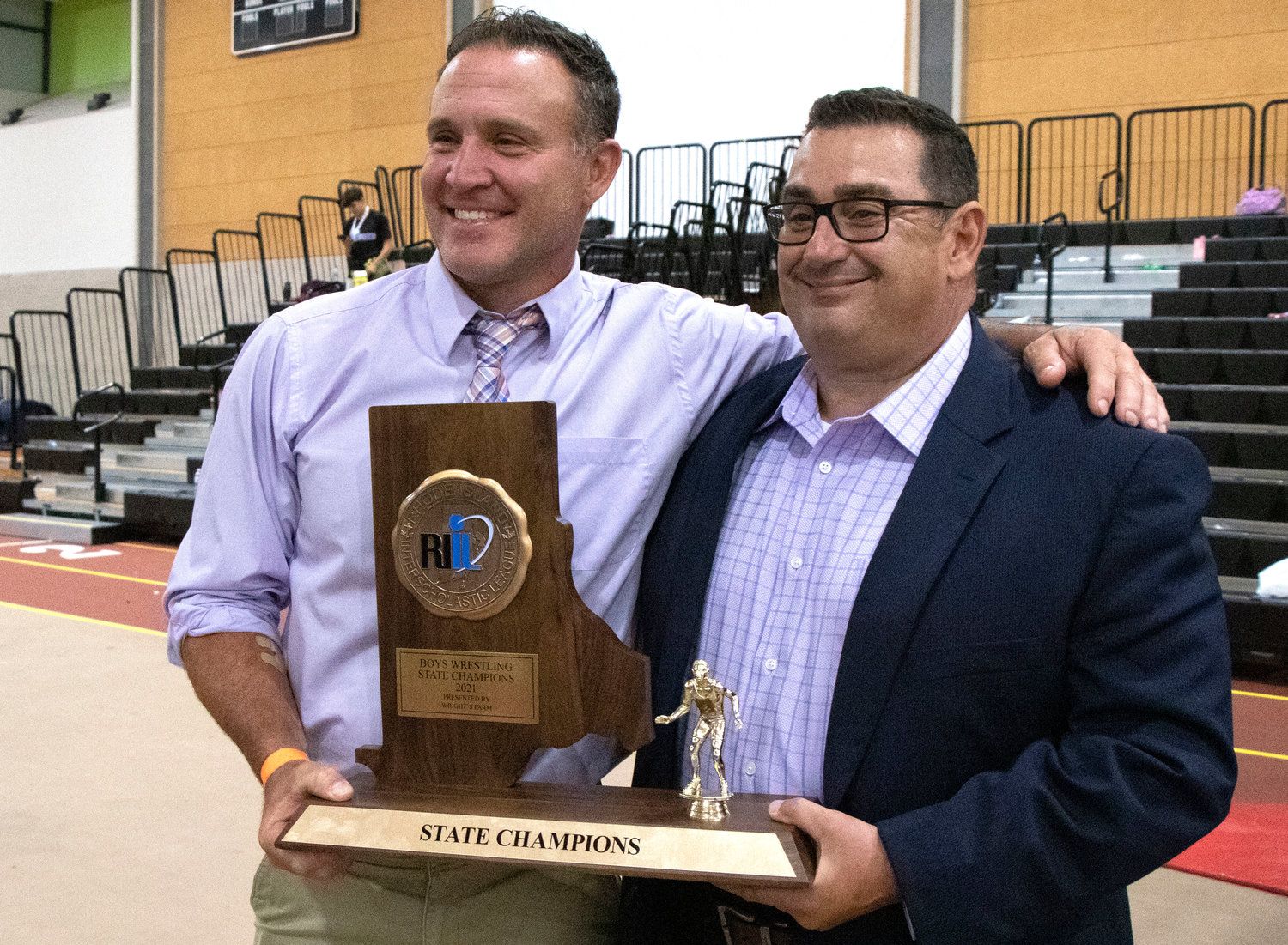 Head coach Eric Francis and assistant, Mike Perreira pose with the championship trophy.
