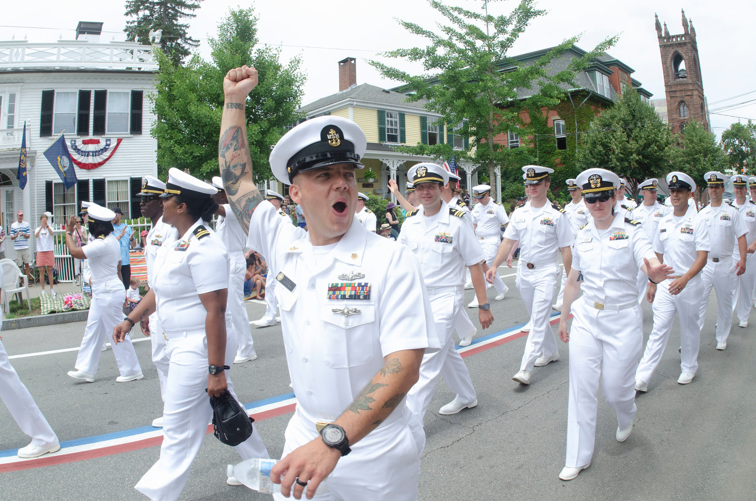 A unit of Naval officers acknowledge the crowd along Hope Street during the 2021 Bristol Fourth of July Parade