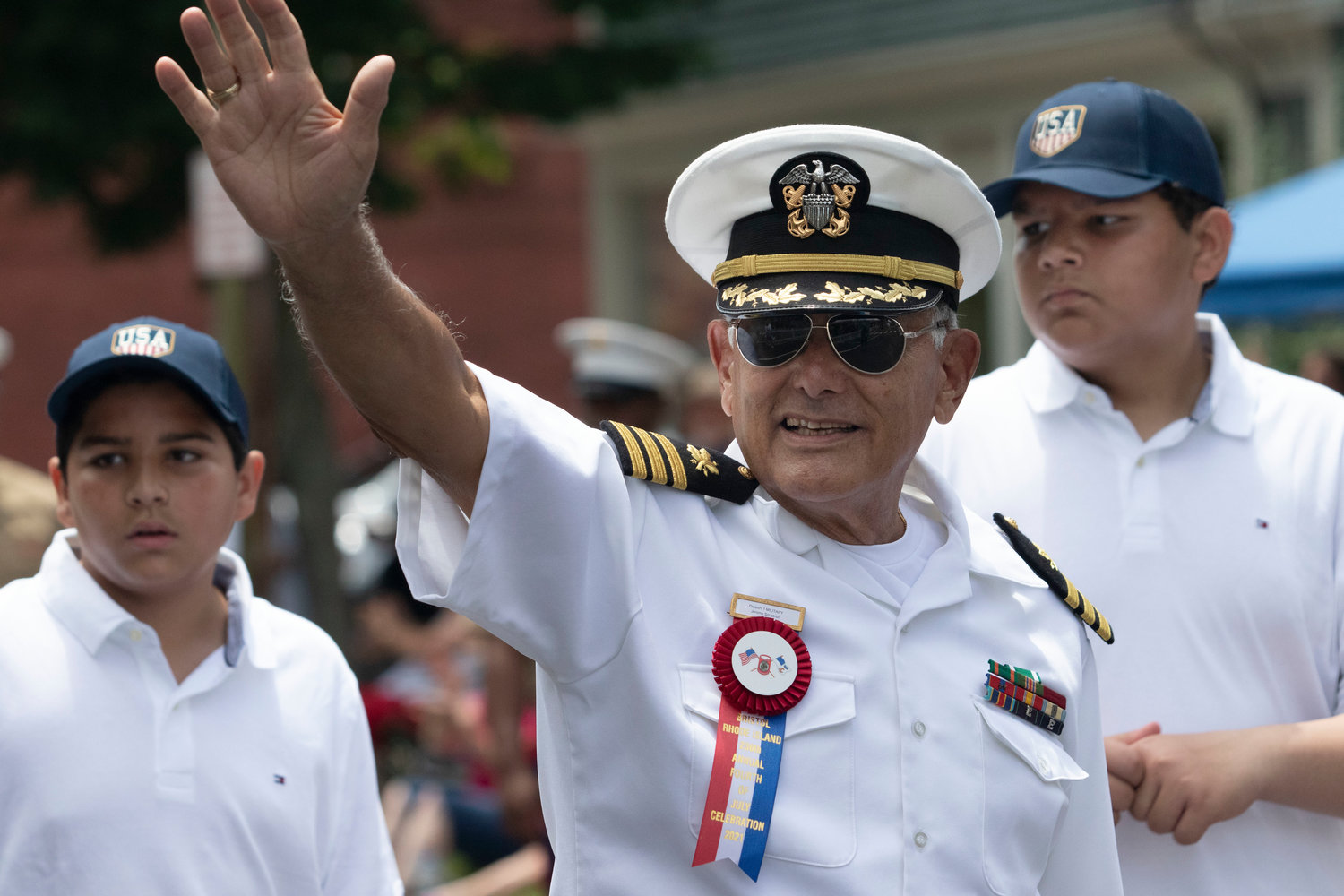Retired Naval officer and Fourth of July Committee member Jerome Squatrito leads a unit down the route.