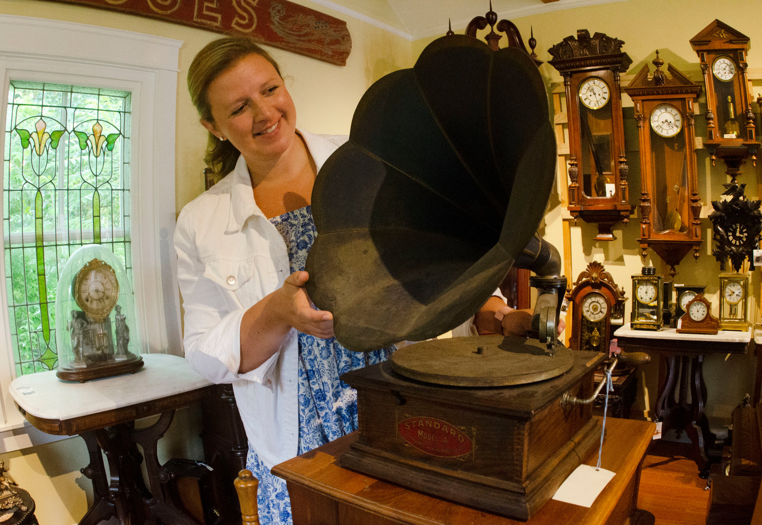 Cory Farms Past & Presents employee Emily Hughes holds up an antique phonograph that’s for sale at the store, which is celebrating its 10th anniversary.