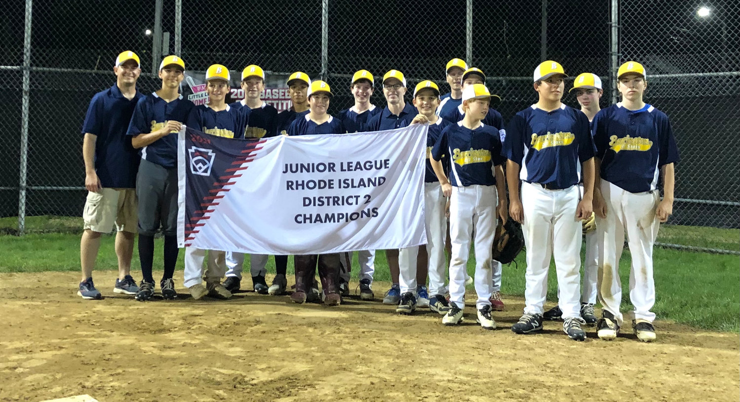 Members of the Barrington Junior Division All-Star baseball team pose with the District 2 championship banner after defeating Pineview on Sunday night.